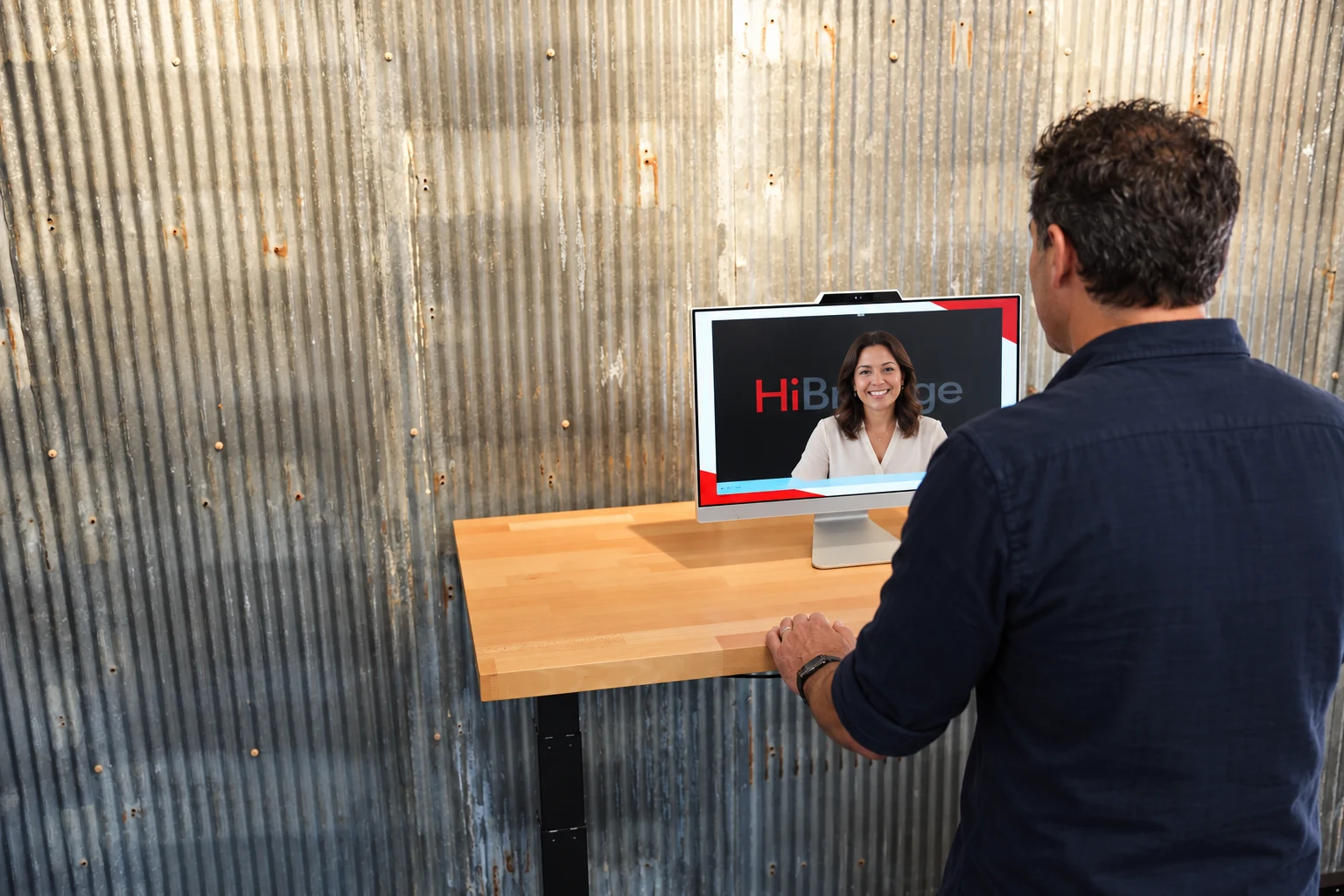 Illustration of a visitor speaking with a live receptionist on a HiBridge kiosk screen.