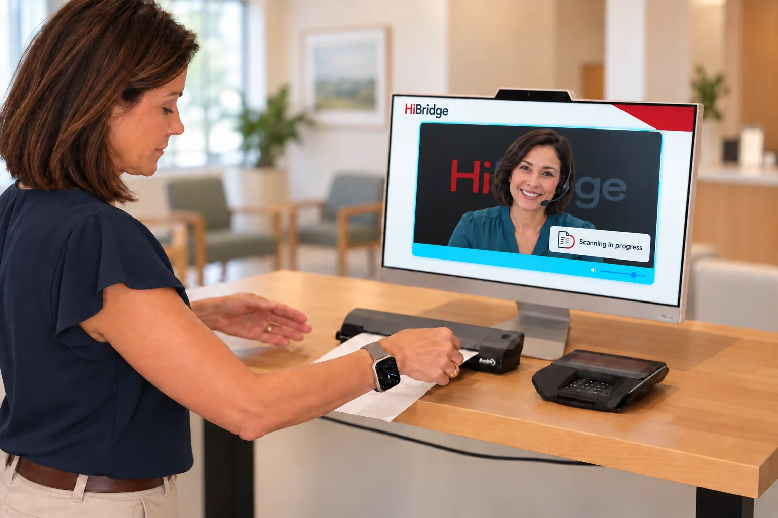 A patient using the document scanner beside a HiBridge check-in kiosk.